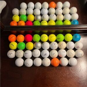 34 random assortment golf balls multicolored and white.